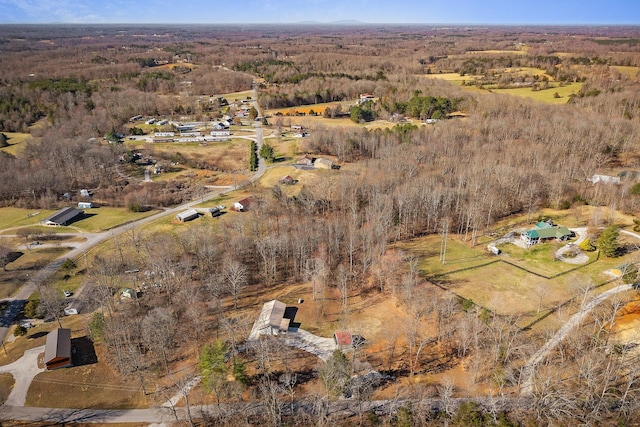 birds eye view of property featuring a view of trees