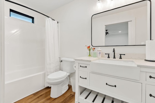 full bath featuring vanity, toilet, wood finished floors, and shower / tub combo with curtain