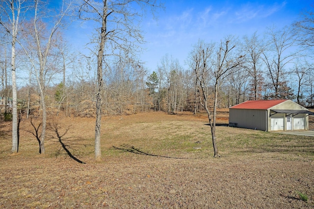 view of yard with a detached garage and an outdoor structure