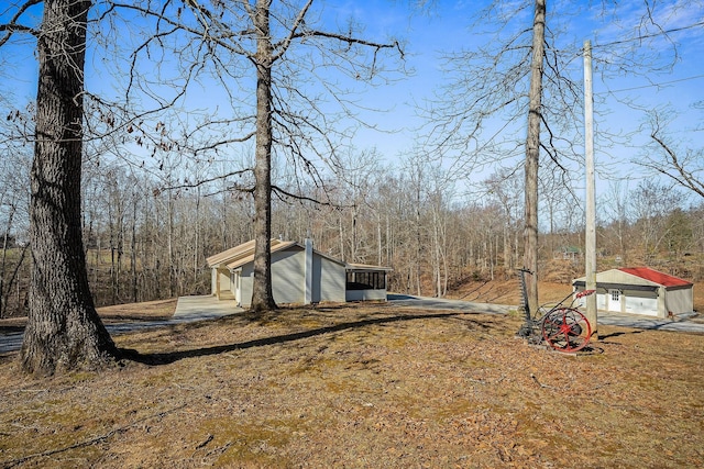 exterior space with an outbuilding and a view of trees