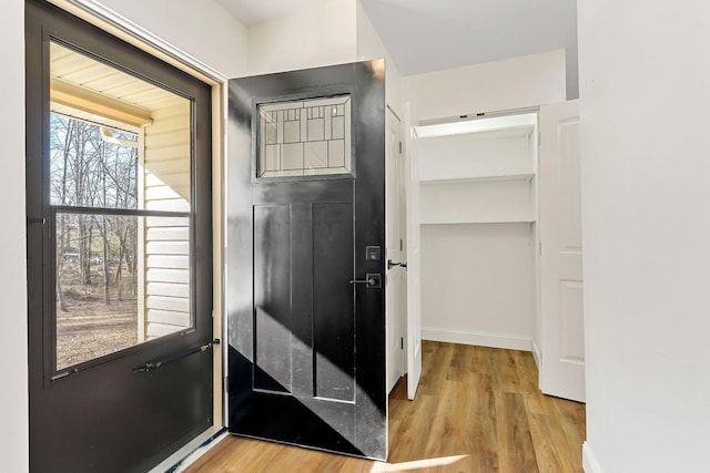 interior space featuring baseboards and light wood-style floors