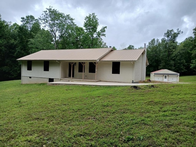 1114 Tanasi Trl, Cookeville, TN 38506 - back of house with a detached garage, a lawn, metal roof, and crawl space