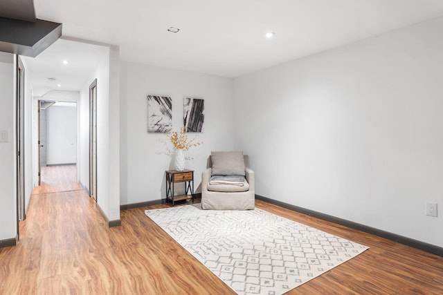 sitting room with recessed lighting, light wood-type flooring, and baseboards