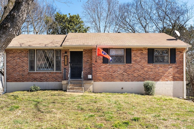 single story home with brick siding, crawl space, a shingled roof, and a front lawn