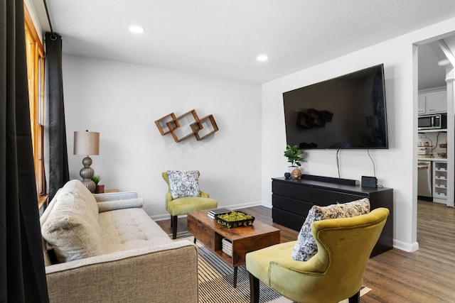 living room with recessed lighting, wood finished floors, and baseboards