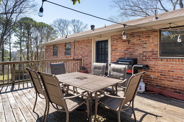 wooden deck featuring outdoor dining space