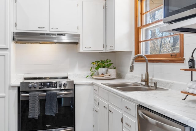 kitchen with under cabinet range hood, a sink, stainless steel appliances, white cabinets, and light countertops