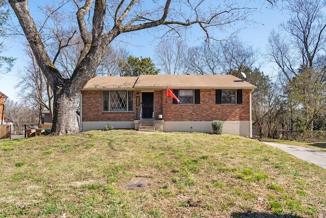 ranch-style house featuring brick siding, a front yard, and fence