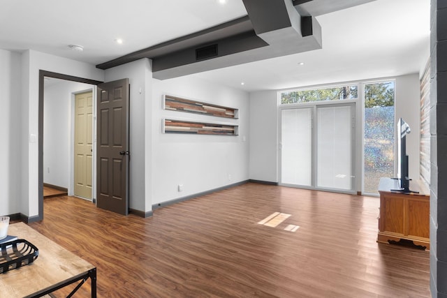 living area with recessed lighting, visible vents, baseboards, and wood finished floors