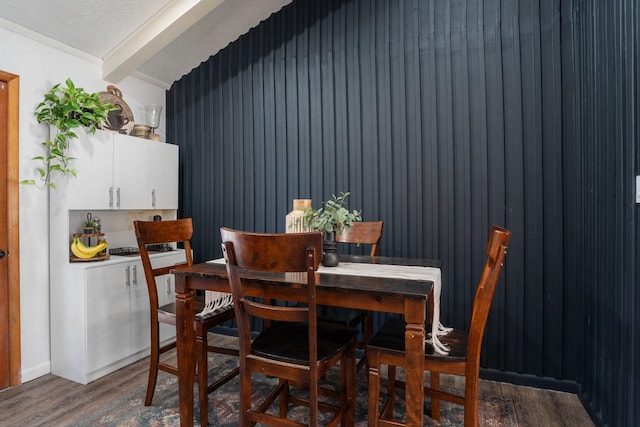 dining space featuring a textured ceiling and wood finished floors