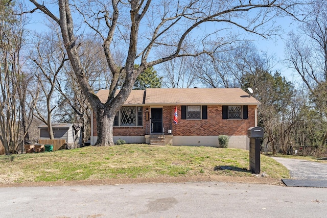 single story home featuring brick siding and a front lawn