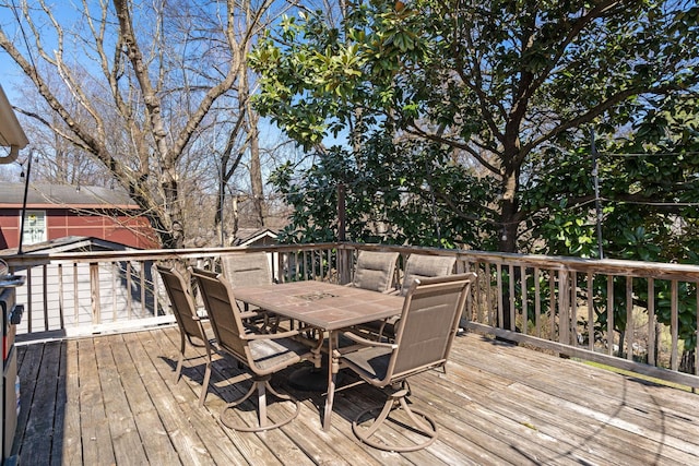 wooden terrace with outdoor dining area