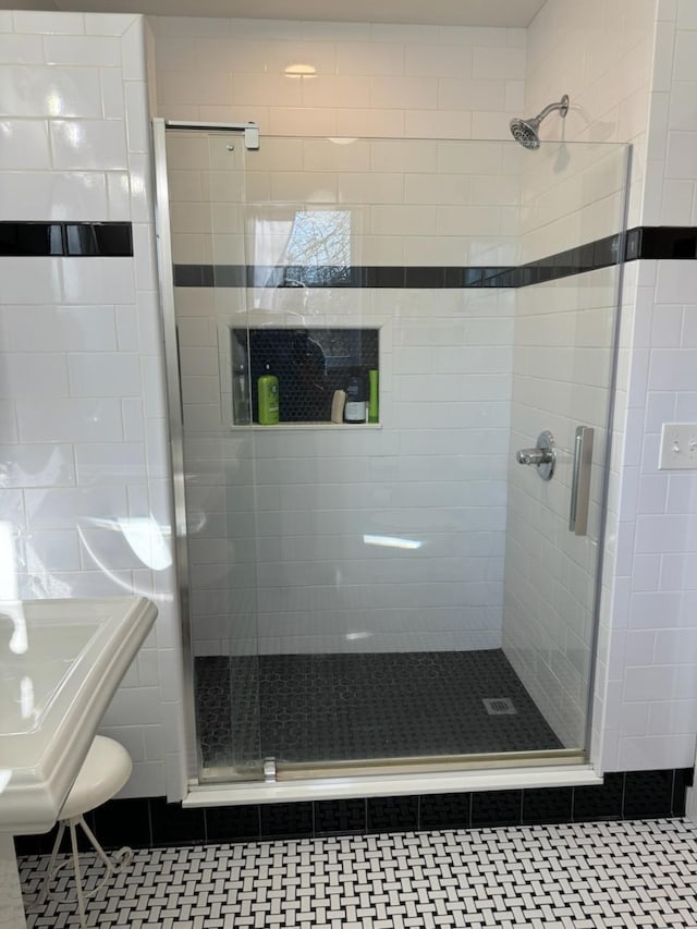 bathroom with a shower stall and tile patterned floors