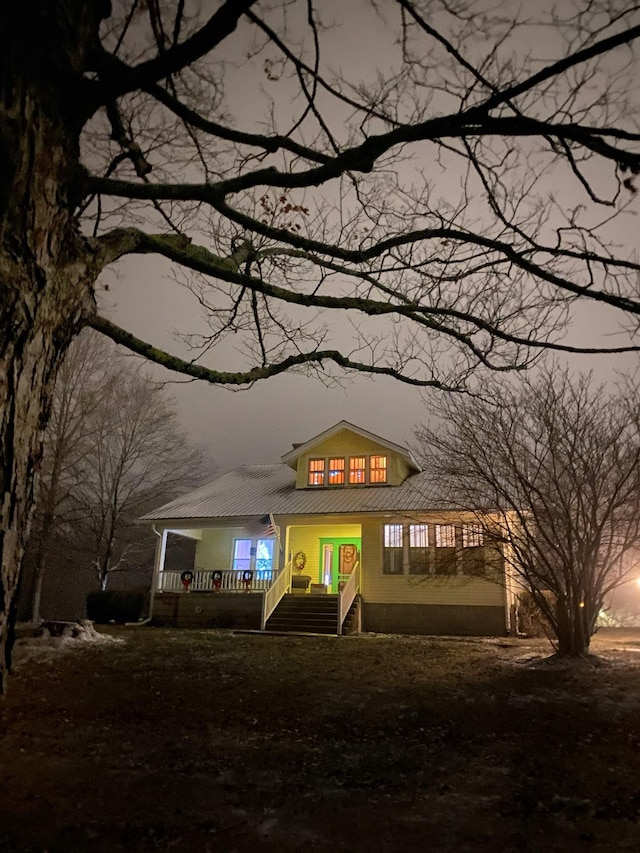 view of front facade featuring covered porch and metal roof