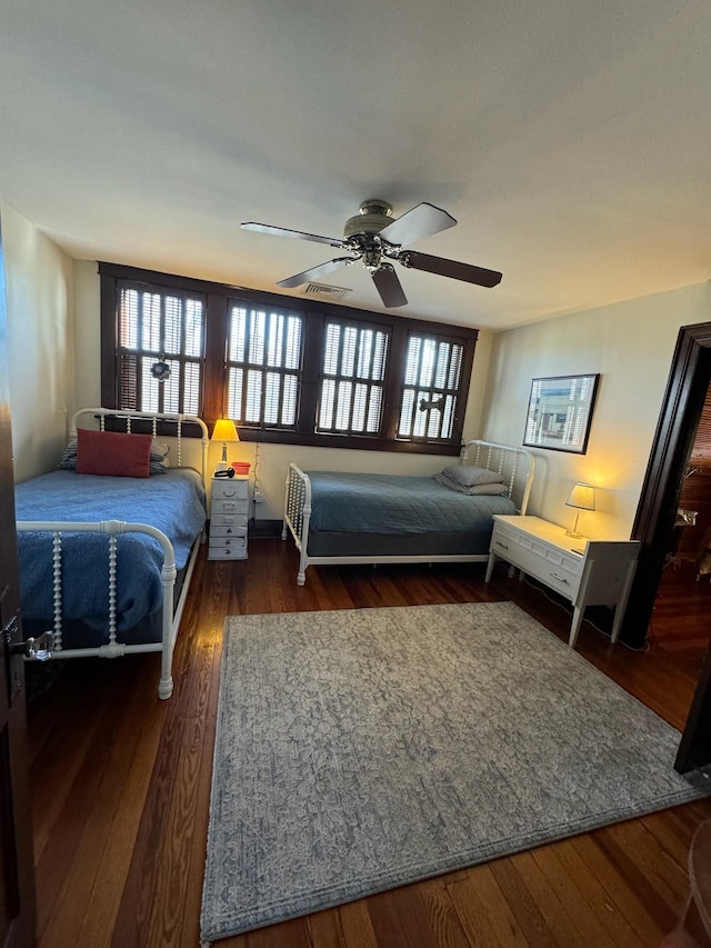 bedroom with visible vents, wood-type flooring, and ceiling fan