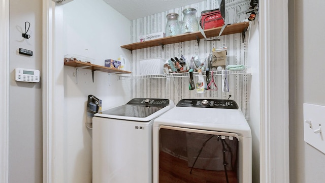 clothes washing area with separate washer and dryer and laundry area