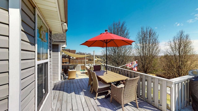 wooden deck with outdoor dining space