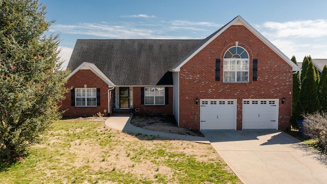 traditional-style home featuring concrete driveway, an attached garage, brick siding, and a front lawn