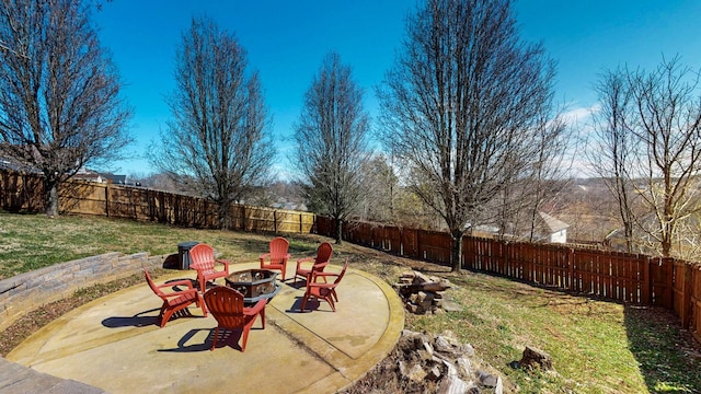 view of yard featuring a fenced backyard, an outdoor fire pit, and a patio