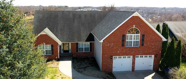 view of front of home with concrete driveway, a garage, and brick siding