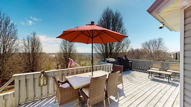 wooden terrace featuring outdoor dining space