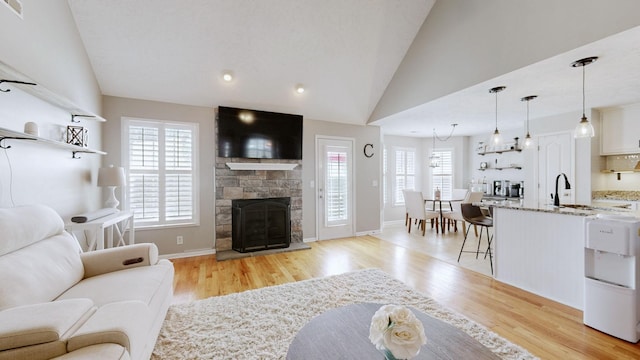 living room featuring lofted ceiling, a wealth of natural light, and light wood finished floors