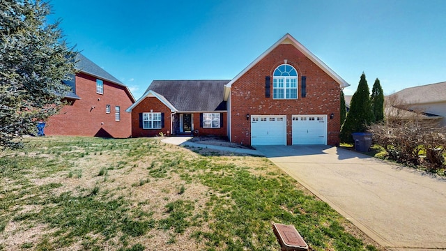 traditional home with a garage, a front lawn, brick siding, and driveway