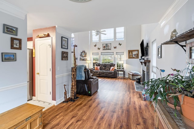 corridor featuring crown molding, baseboards, and wood finished floors