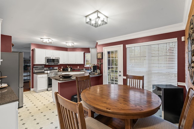 dining area with light floors and ornamental molding