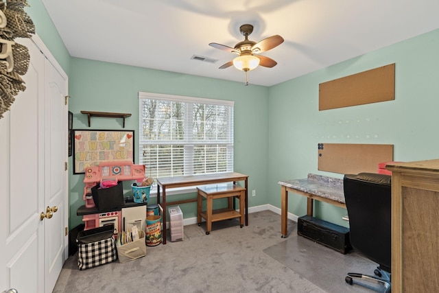 office area featuring visible vents, carpet flooring, baseboards, and ceiling fan