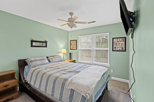 carpeted bedroom featuring visible vents, a ceiling fan, and baseboards