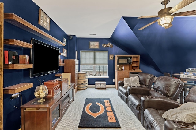 carpeted living area with lofted ceiling, baseboards, and ceiling fan