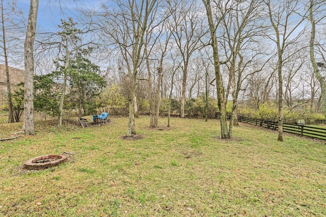 view of yard featuring a fire pit and fence