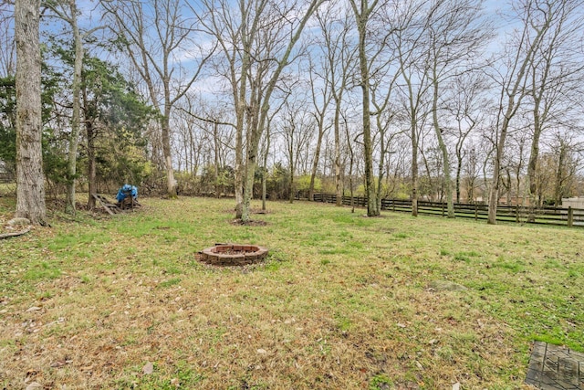 view of yard featuring a fire pit and fence