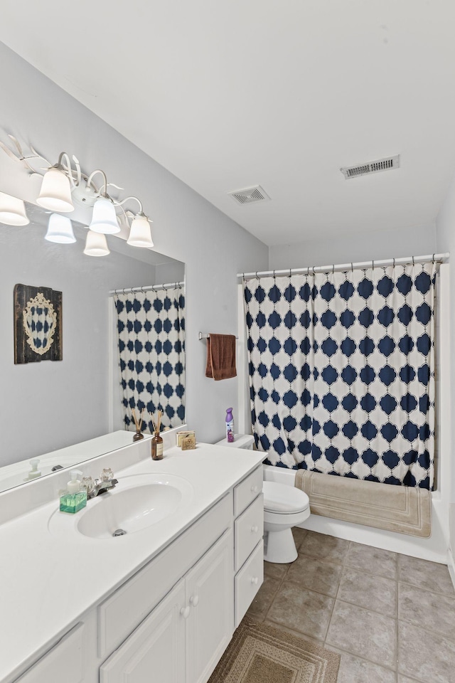 bathroom with tile patterned floors, visible vents, toilet, and vanity