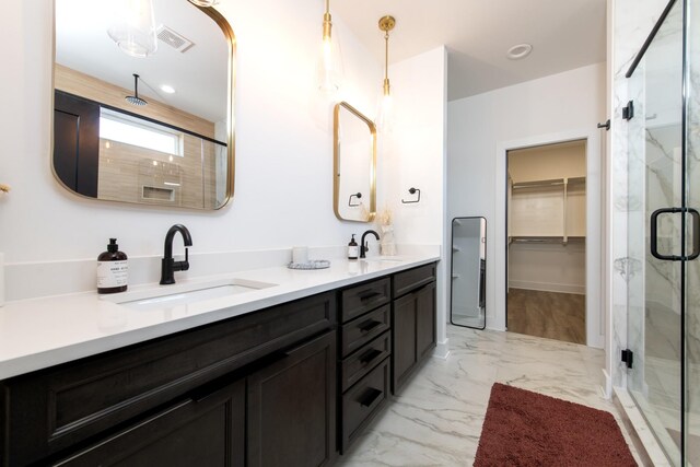 full bath featuring visible vents, marble finish floor, a stall shower, a sink, and double vanity