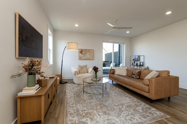 living area with recessed lighting, wood finished floors, baseboards, and ceiling fan