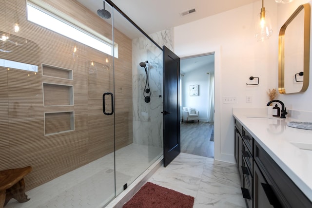 full bathroom with visible vents, marble finish floor, a stall shower, a sink, and double vanity