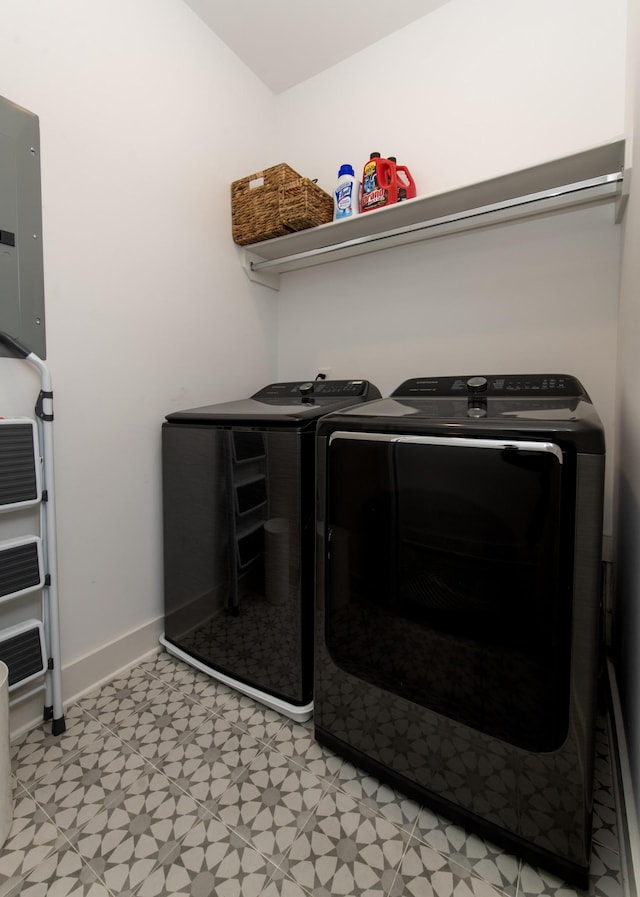 washroom with baseboards, light floors, electric panel, laundry area, and independent washer and dryer