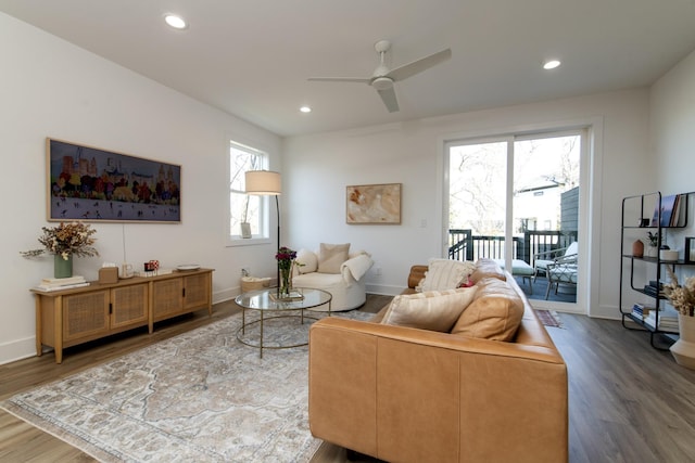 living area featuring recessed lighting, baseboards, and wood finished floors