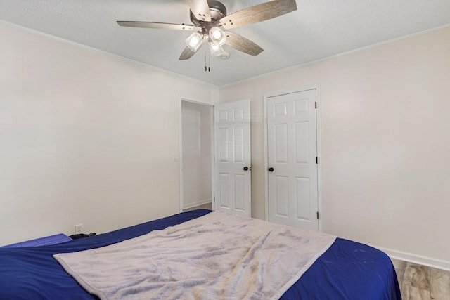 bedroom featuring baseboards and ceiling fan