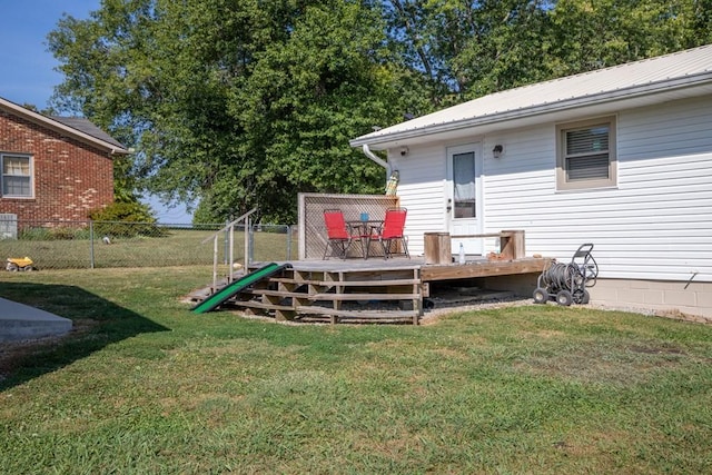 view of yard with a deck and fence