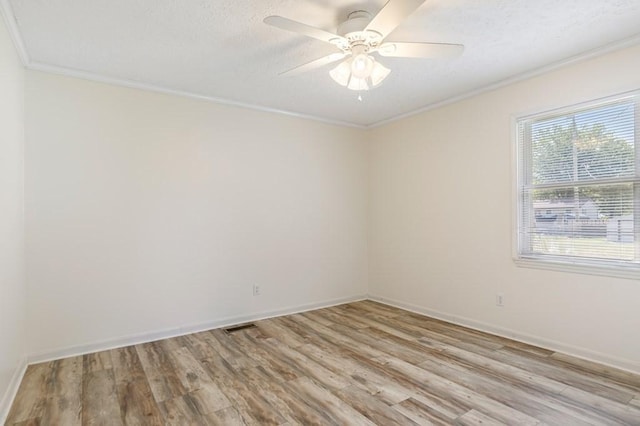 unfurnished room with light wood-type flooring, a textured ceiling, ornamental molding, and a ceiling fan