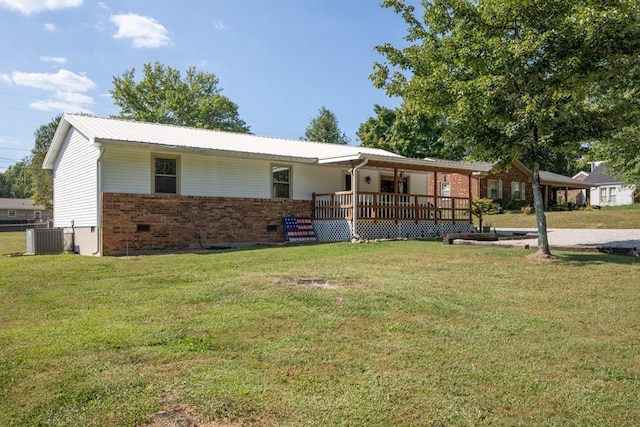 single story home with brick siding, central AC, metal roof, and a front lawn