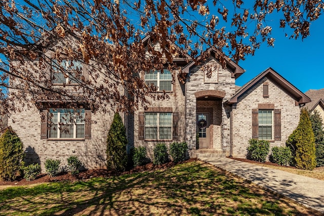 view of front of home with brick siding and a front yard