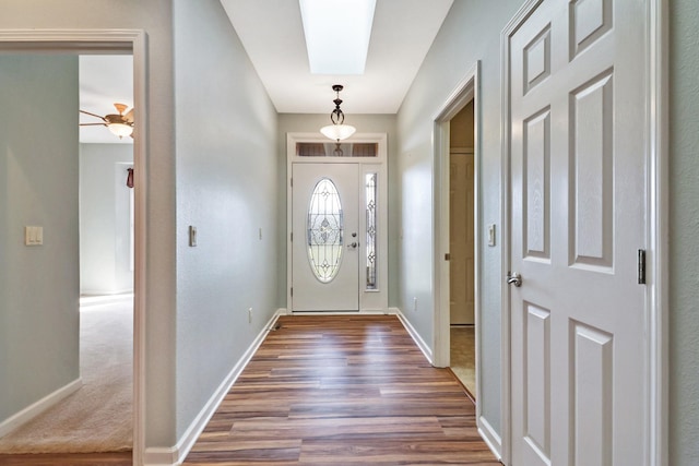 entrance foyer with dark wood-type flooring, visible vents, and baseboards