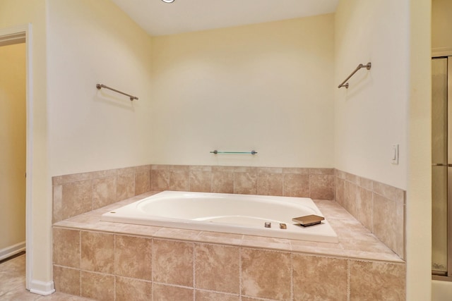 full bathroom featuring tile patterned floors and a bath