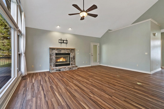 unfurnished living room with high vaulted ceiling, a ceiling fan, a stone fireplace, baseboards, and dark wood-style flooring