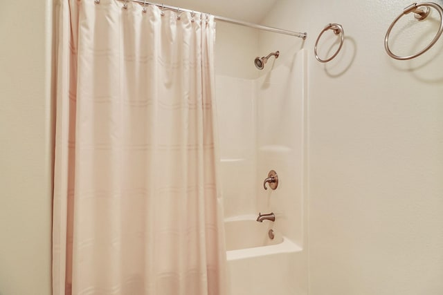 bathroom with shower / bath combo with shower curtain