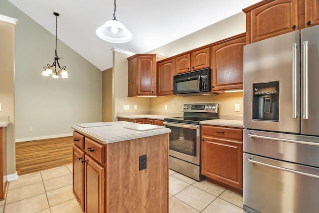 kitchen featuring light tile patterned flooring, appliances with stainless steel finishes, a center island, and light countertops